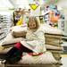 Ann Arbor resident Lily Happ, seven, sits on a pile of bird feed at Pet Supplies Plus after being photographed on Saturday. Her family says they enjoy the opportunity to donate to the humane society. Daniel Brenner I AnnArbor.com